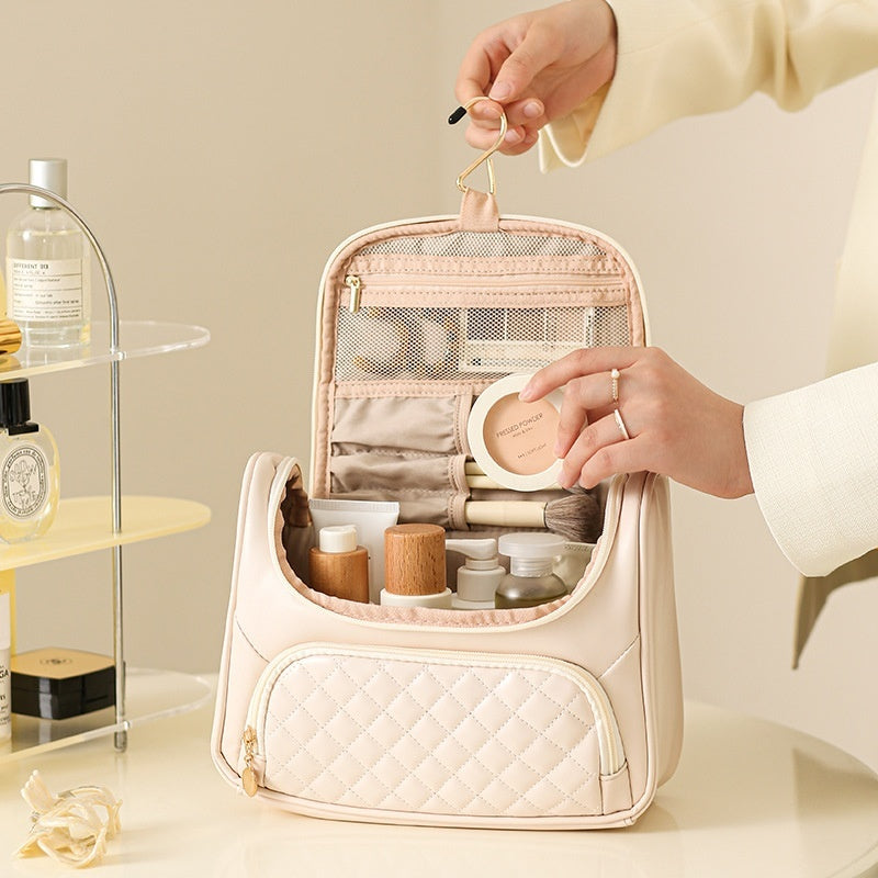 Milky white vanity bag, open with mesh organizer pockets and zip compartments