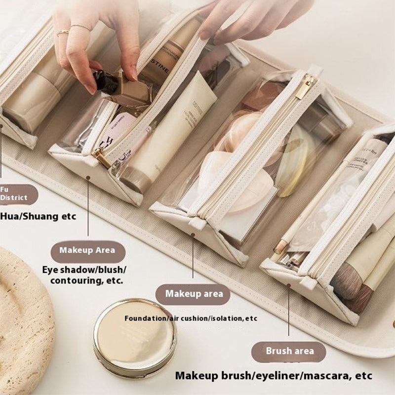 Light beige folding travel vanity bag with gold-tone hardware and curved top handles.