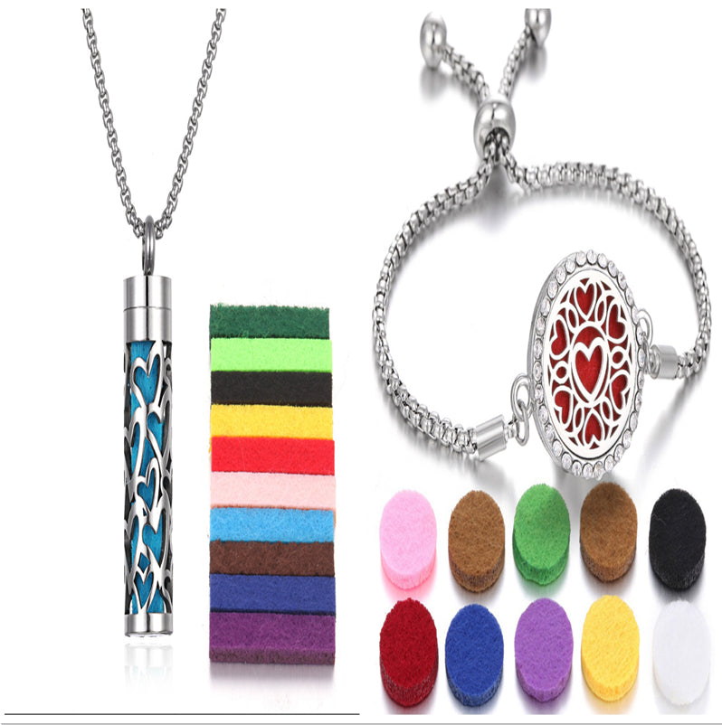 Silver-tone locket bracelet with colored aroma pads plus blue pattern roller vial