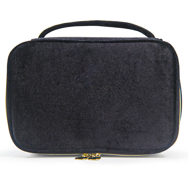Soft travel cosmetic case in dark gray/black with top handle and gold zipper pull