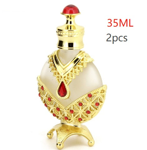 Perfume oil vial with red cap and gold base, white body with red gem band