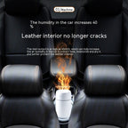 White car aroma diffuser emitting vapor plume in vehicle console area.