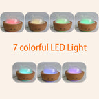 Aroma diffuser with light wood grain base and glowing multicolor LED light
