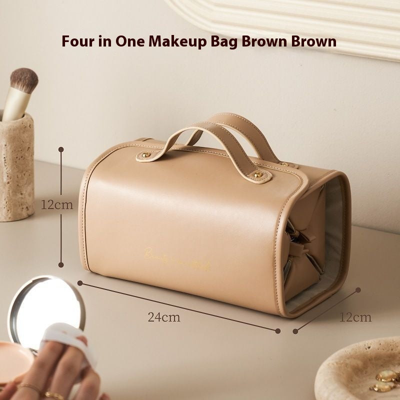 Brown folding travel vanity bag with two top handles and gold-tone snap clasp.