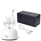 Aroma diffuser with white base, flame-like glass outlet, and USB power cable