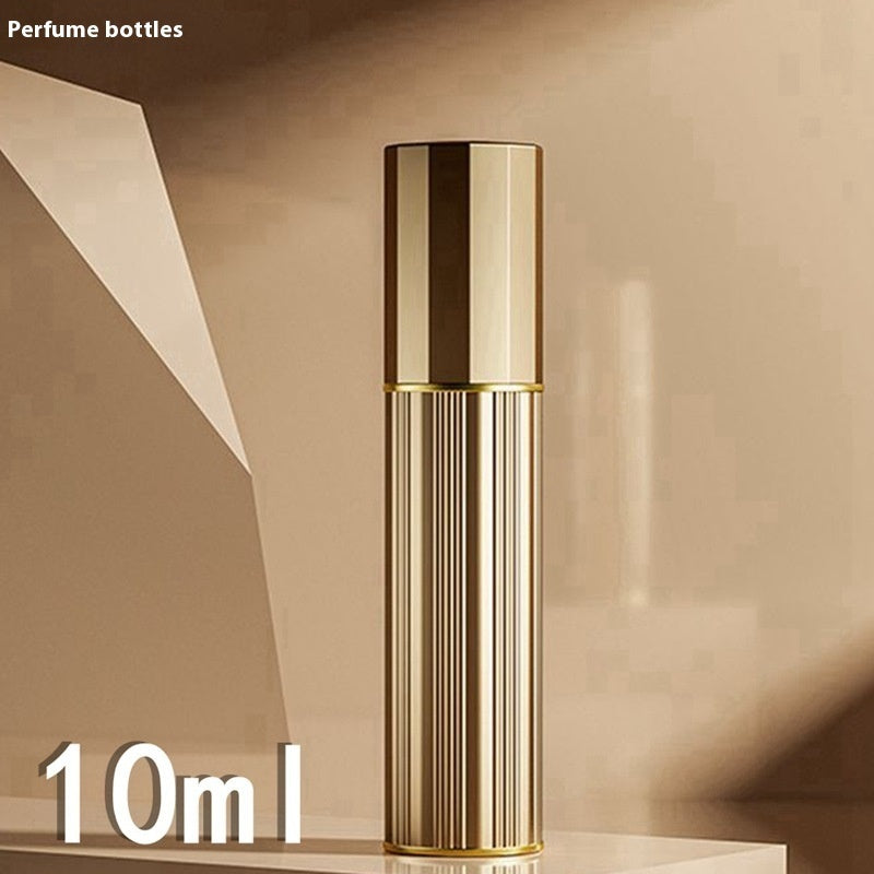 Gold-toned travel perfume atomiser with ribbed cylindrical body and capped top