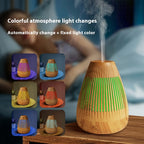 Ultrasonic essential oil diffuser with colorful LED light and vertical vent openings, misting