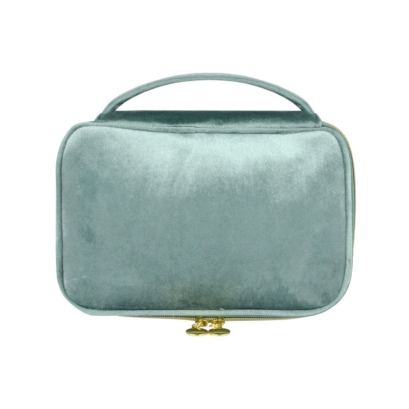 Light blue soft travel cosmetic case with top handle and gold zip pull